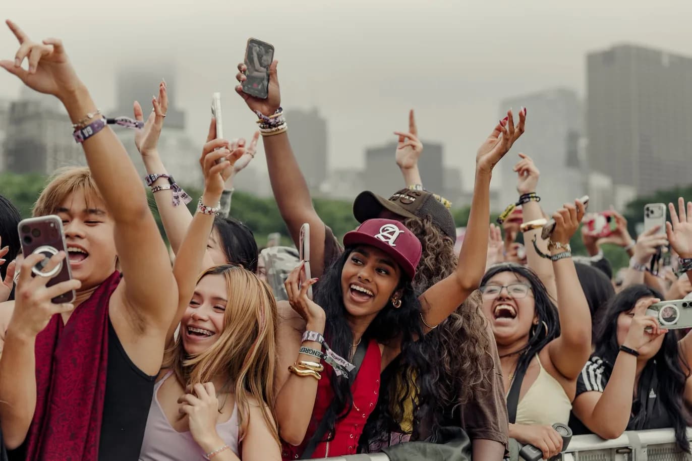Festival crowd cheering with their phones and hands in the air